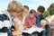 Students with handbooks in school yard