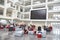 Students meeting in front of screen in atrium at university