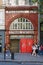 Students passing in front of the Entrance to the disused London Underground Aldwych Tube Station on The Strand