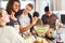 Students prepare salad together in shared kitchen