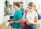 Students record and photograph class schedules in college lobby