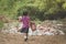 Students remove rubbish from the classroom to pile waste in school