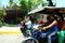 Students riding a tricycle to get to school