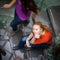 Students rushing up and down a busy stairway -  young female student looking upwards