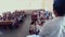 Students sit on the benches while the teacher teaches in the classroom