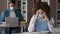 Students study in library young focused woman in medical mask sitting at desk tired girl reading book preparing for exam