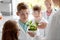 Students and teacher with plant at biology class