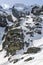 Students under the supervision of an instructor on a winter mountaineering course learn how to safely walk in the winter in the mo