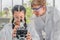 Students using microscope in science laboratory class