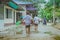 Students walk to the flood after rain