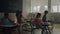 Students walking in classroom at school. Schoolchildren sitting at desks