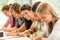 Students writing at high-school exam teens study