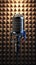 Studio ambiance Silver retro microphone against soundproof studio walls