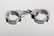 Studio close-up of a locked pair of hiatt type handcuffs