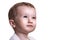 Studio closeup portrait of little baby boy looking full of expectations to the right, isolated on white background