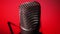 Studio condenser microphone rotates on red background.