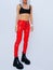 Studio Fashion Portrait Of Model Wearing red leather pants and trendy  platform boots.  90s clubbing street outfit