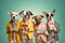 Studio group photo portrait of four five dogs dressed in bright colored clothes created with Generative AI technology