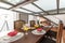 Studio living room with rectangular wooden dining table with lots of assorted fruits,