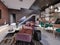 Studio loft design with staircase and dark brick wall. Living room with burgundy upholstered furniture and a modern kitchen