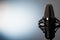 Studio microphone with effective lighting on a gray background. Concept. Radio presenters, bloggers, singers, track recording,