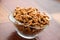 Studio photo of bowl with heap of peeled walnuts