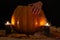 The studio photo of burning candles. Human hand on Pumpkin with spider and spiderweb on a black background. Halloween conceptual