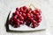 A Studio Photograph of a Bunch of `Flame` Variety Grapes on a Serving Plate