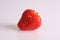 A studio photograph of a fresh strawberry against a white background