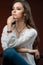 Studio photography. Portrait of a beautiful brunette Model with silver jewelry collection and long hair