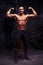 Studio photoshooting of bare-chested muscular athlete with healthy strong body