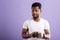 Studio portrait of american man posing with smartphone