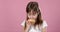 Studio portrait of a beautiful little girl holding a donut and smelling tasty flavour