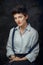 Studio portrait of beautiful pensive middle age brunette Caucasian woman looking in camera