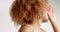 Studio portrait of beauty black woman dancing in sun visor