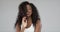 Studio portrait of black woman shaked head and her curly hair