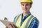 Studio Portrait Of Builder Architect With Clipboard Against White Background