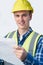 Studio Portrait Of Builder Architect Looking At Plans Against White Background