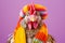 Studio portrait of a chicken or hen wearing knitted hat, scarf and mittens. Colorful winter and cold weather concept