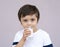 Studio portrait of Cute toddler drinking fresh milk from a glass, Healthy kid boy wearing white shirt with smiling face and