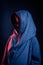 Studio portrait of a dark-haired boy, on a dark background, in a hoodie jacket. Positive emotion, smile on your face