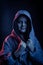 Studio portrait of a dark-haired boy, on a dark background, in a hoodie jacket. Positive emotion, smile on your face