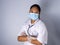 Studio portrait of a female doctor wearing a mask standing on a white background There was a slight light on his face