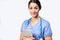 Studio Portrait Of Female Nurse Wearing Scrubs Holding Digital Tablet