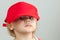 Studio portrait of funny baby girl in big red baseball cap