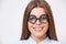 Studio portrait of funny young business woman in nerd glasses