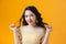 Studio portrait of graceful girl in yellow dress with smile