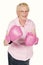 A studio portrait of a grandma wearing pink boxing gloves isolated on white.