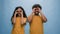 Studio portrait Indian family Arabian couple Hispanic man woman looking through hands make circles shape binoculars