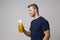 Studio Portrait Of Male Nutritionist With Drinks Bottle